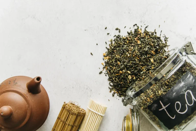 Szálas zöld tea üvegtartóból kiszórva, az L-teanin természetes forrása